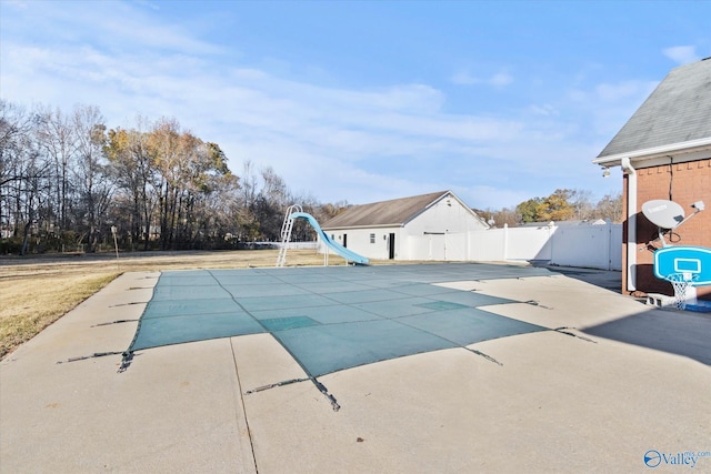 view of pool with a patio area and a water slide