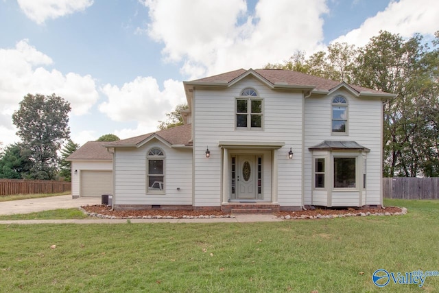 view of property with a garage and a front lawn