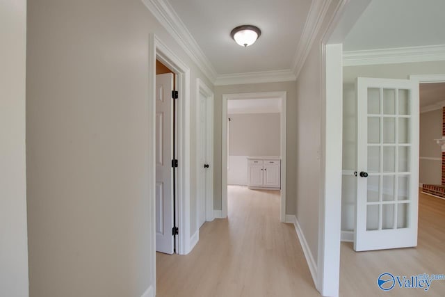 hall featuring light hardwood / wood-style floors and crown molding