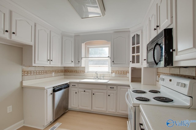 kitchen featuring white cabinetry, sink, decorative backsplash, white range with electric stovetop, and dishwasher