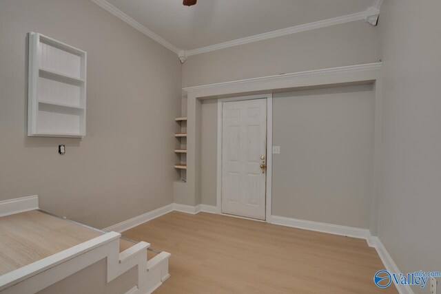 foyer featuring hardwood / wood-style flooring and crown molding