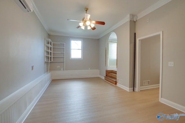 119 Victoria Dr, Madison, AL 35758 - empty room featuring light wood-type flooring, a ceiling fan, ornamental molding, a wall mounted AC, and arched walkways