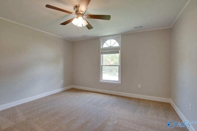 carpeted spare room featuring ceiling fan and crown molding