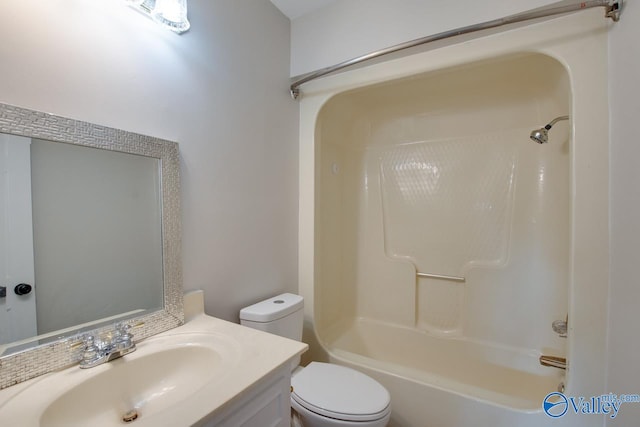 full bathroom with toilet, vanity, and shower / washtub combination