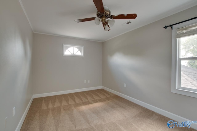 carpeted empty room with ceiling fan and crown molding