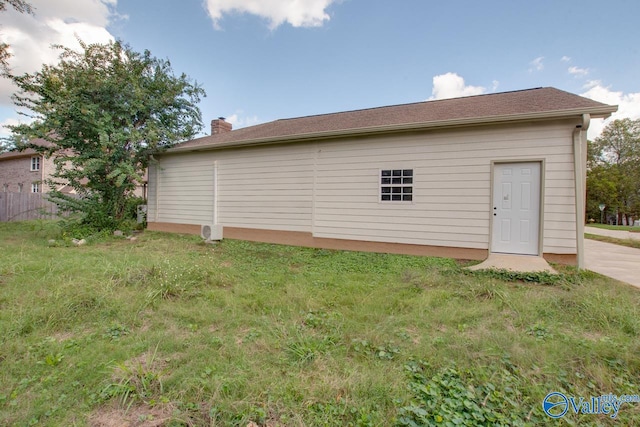 rear view of property featuring a yard