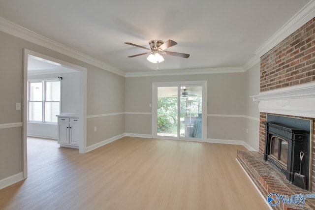 unfurnished living room with ornamental molding, a fireplace, light hardwood / wood-style floors, and ceiling fan