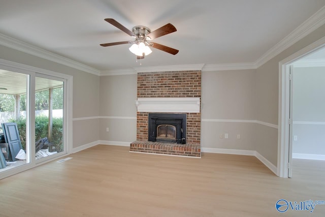 unfurnished living room with a brick fireplace, light hardwood / wood-style floors, ceiling fan, and ornamental molding