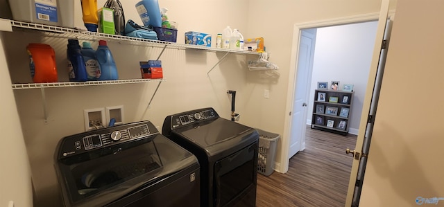 laundry area with dark hardwood / wood-style flooring and washing machine and dryer