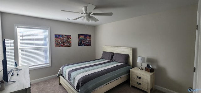 carpeted bedroom with ceiling fan and multiple windows