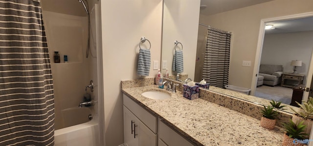 bathroom featuring shower / bath combo with shower curtain and vanity