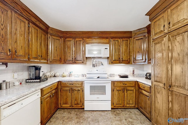 kitchen with white appliances and backsplash