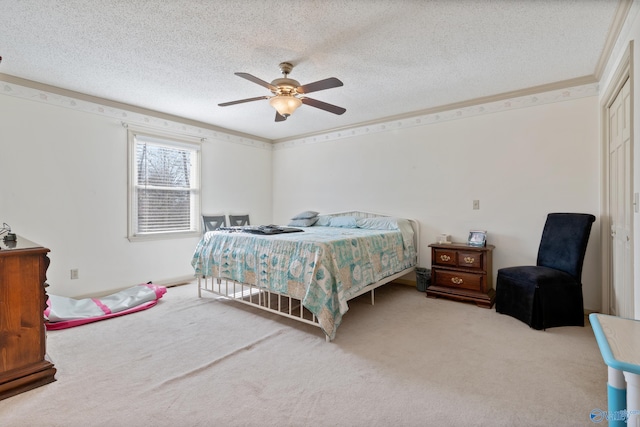 carpeted bedroom featuring a textured ceiling and ceiling fan