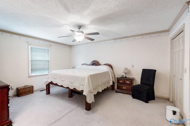 bedroom with light colored carpet, ceiling fan, and a closet