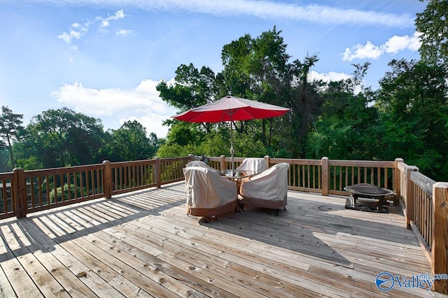 wooden deck with an outdoor fire pit