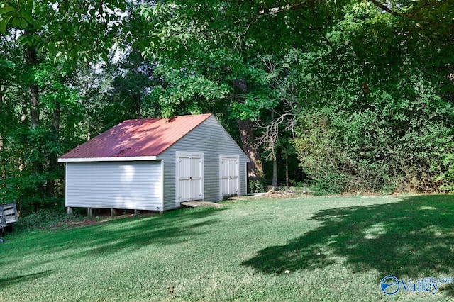 view of outbuilding with a yard