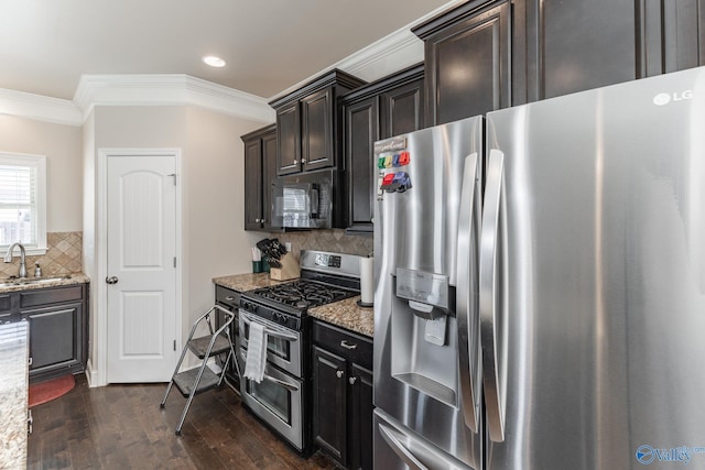 kitchen with sink, crown molding, appliances with stainless steel finishes, dark hardwood / wood-style floors, and light stone counters