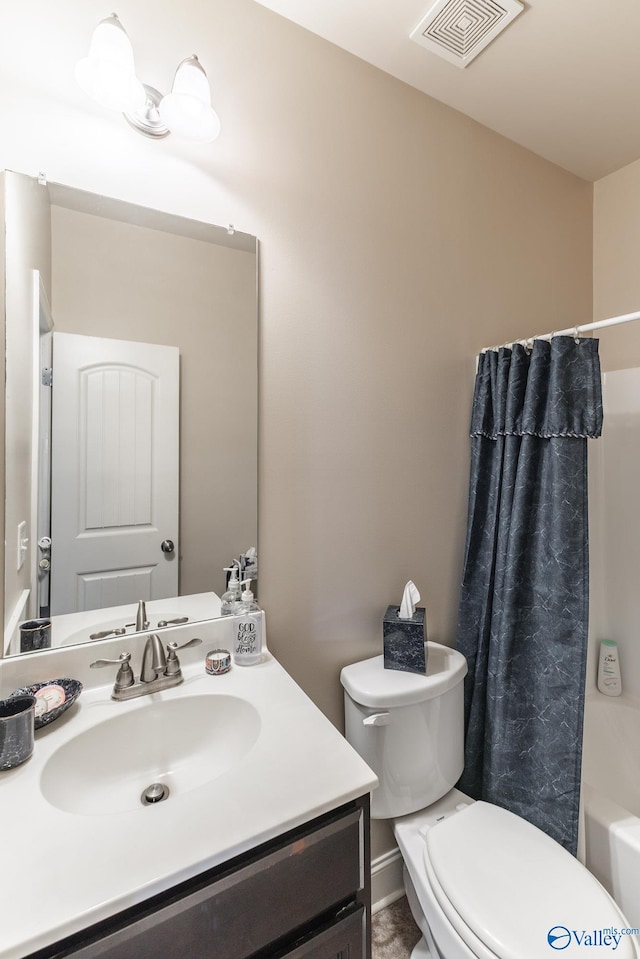 full bathroom with vanity, shower / bath combo with shower curtain, and toilet