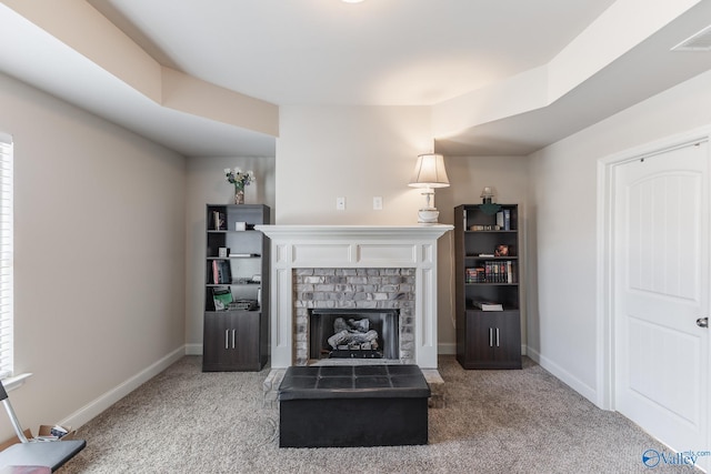 carpeted living room with a brick fireplace