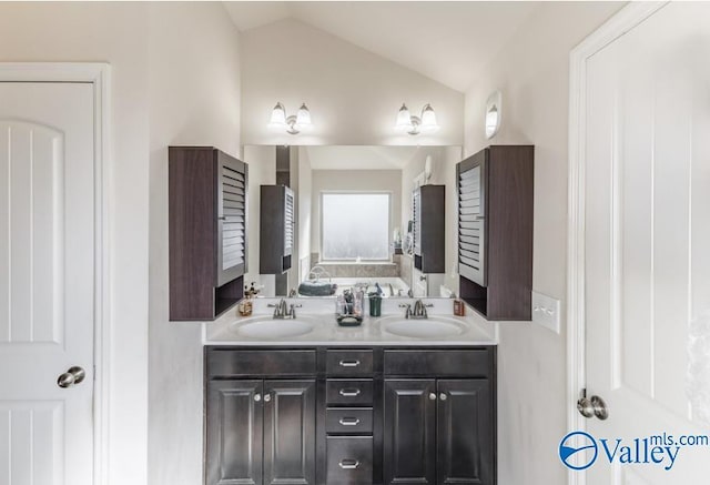 bathroom featuring vanity and vaulted ceiling