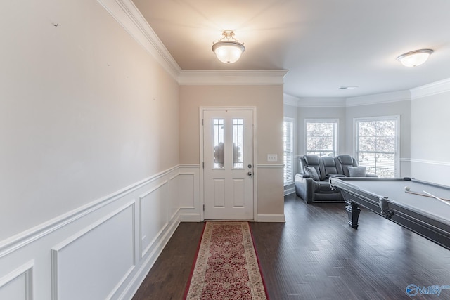 entrance foyer featuring billiards, ornamental molding, and dark hardwood / wood-style floors