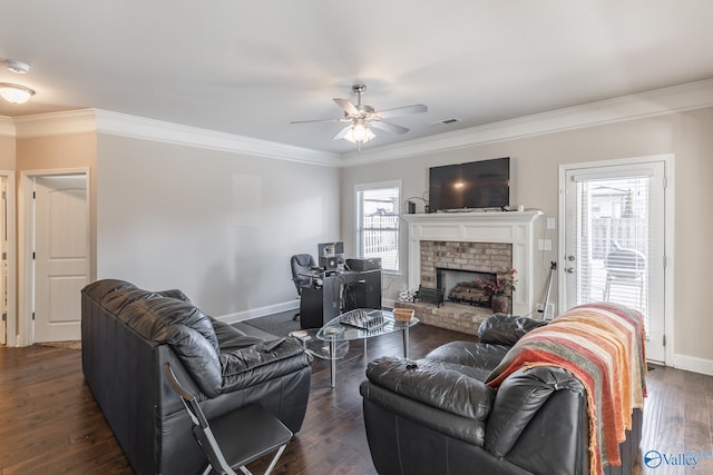 living room with crown molding, a brick fireplace, dark hardwood / wood-style floors, and ceiling fan