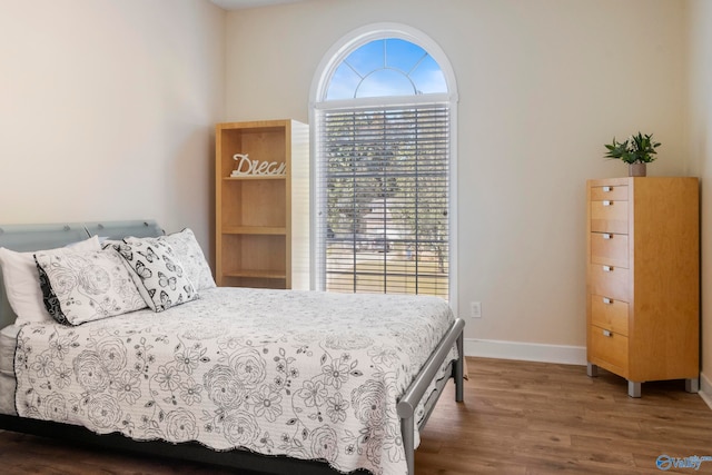 bedroom with dark wood-type flooring