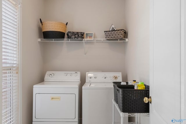 washroom featuring a wealth of natural light and independent washer and dryer