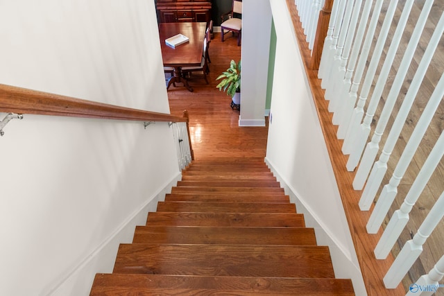 stairs with hardwood / wood-style flooring