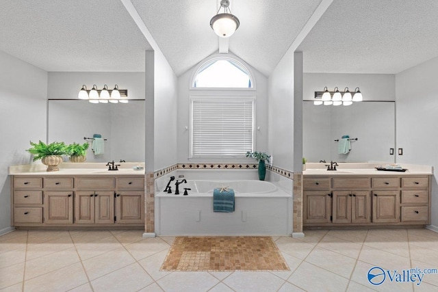 full bath with two vanities, vaulted ceiling, tile patterned flooring, and a sink