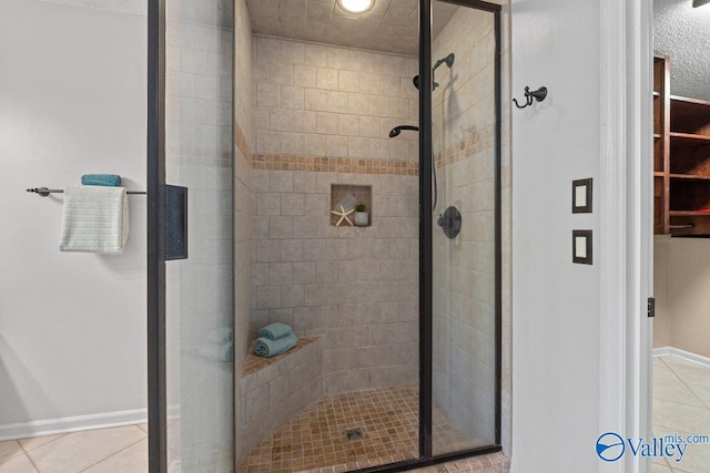 full bathroom featuring tile patterned flooring and a stall shower