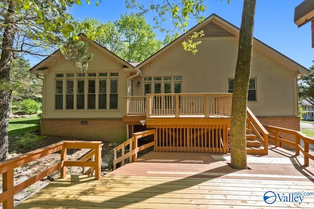 rear view of house with a deck and stairs