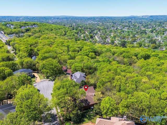 birds eye view of property featuring a wooded view