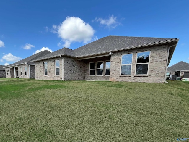 rear view of house with a lawn