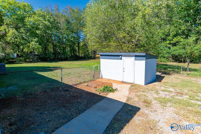 view of outbuilding featuring a yard and cooling unit