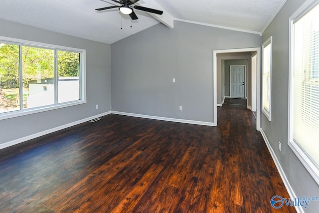 spare room with a textured ceiling, lofted ceiling with beams, dark hardwood / wood-style floors, and ceiling fan