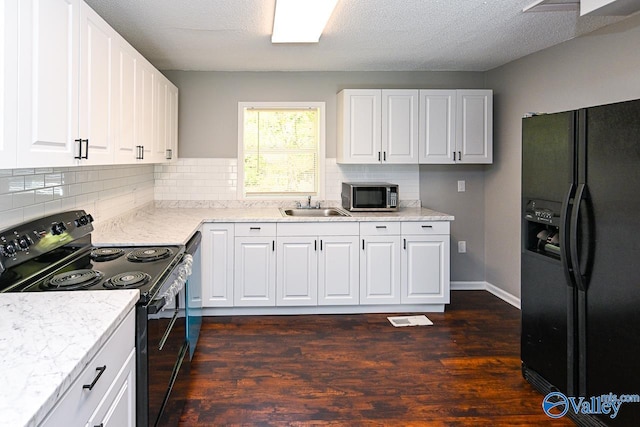 kitchen featuring white cabinets, black appliances, sink, and dark hardwood / wood-style flooring