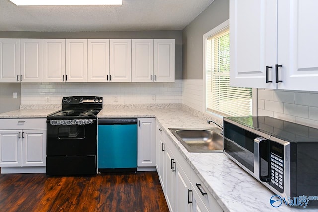 kitchen with decorative backsplash, dark hardwood / wood-style floors, sink, white cabinets, and appliances with stainless steel finishes