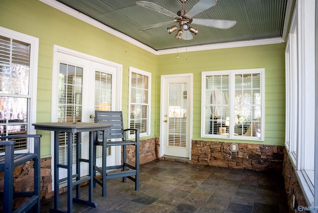 sunroom featuring a healthy amount of sunlight and ceiling fan