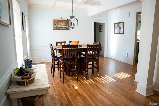 dining space with an inviting chandelier, coffered ceiling, beam ceiling, and hardwood / wood-style flooring