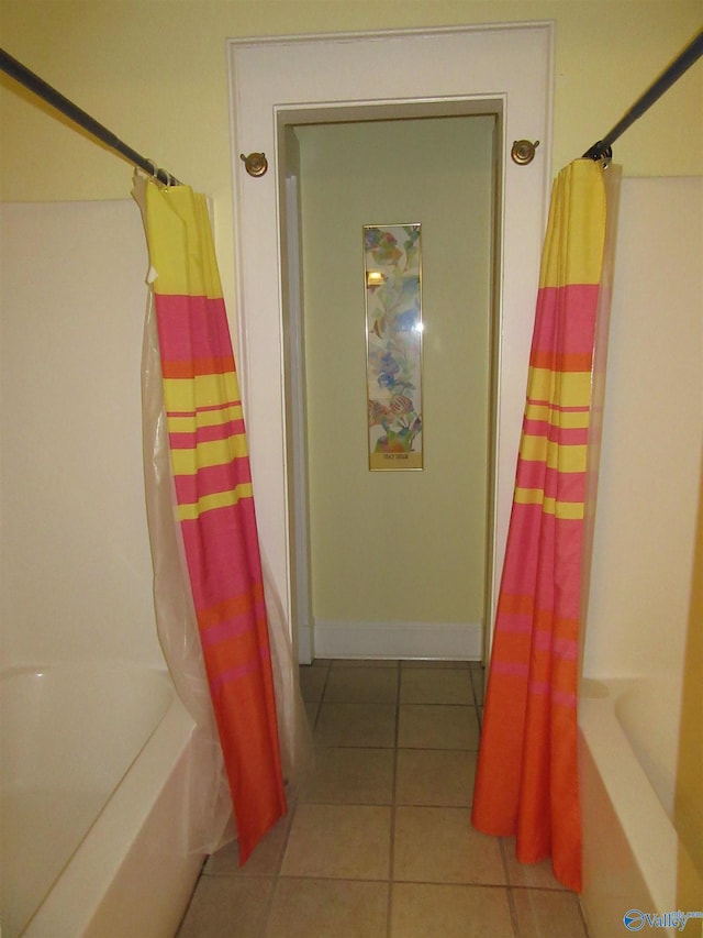 bathroom with tile patterned floors and shower / tub combo