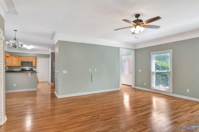 133 Raccoon Trce, Huntsville, AL 35806 - unfurnished living room with crown molding, a chandelier, light wood-style floors, and ceiling fan
