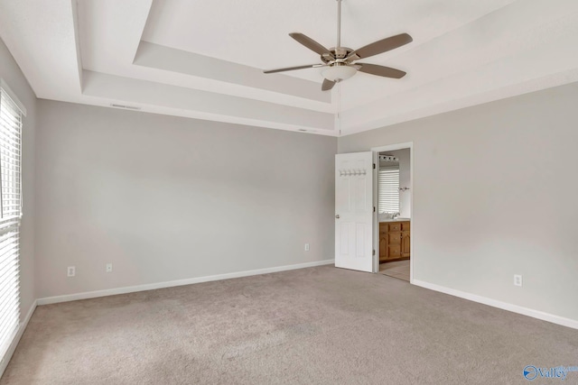 133 Raccoon Trce, Huntsville, AL 35806 - spare room with a ceiling fan, light carpet, and a tray ceiling