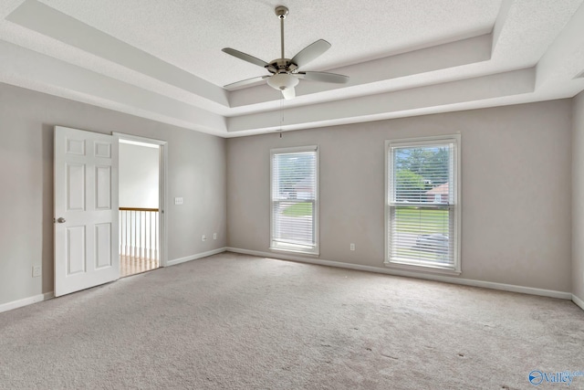 133 Raccoon Trce, Huntsville, AL 35806 - spare room featuring a raised ceiling, a textured ceiling, carpet flooring, and ceiling fan