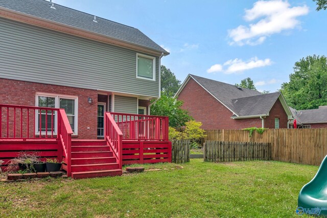 133 Raccoon Trce, Huntsville, AL 35806 - rear view of property featuring a wooden deck, a playground, and brick siding