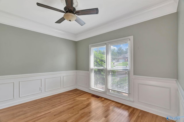 133 Raccoon Trce, Huntsville, AL 35806 - unfurnished room featuring crown molding, a wainscoted wall, light wood-style floors, and ceiling fan