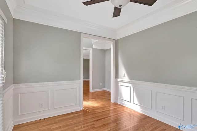 133 Raccoon Trce, Huntsville, AL 35806 - spare room featuring a ceiling fan, crown molding, light wood-style floors, wainscoting, and a decorative wall
