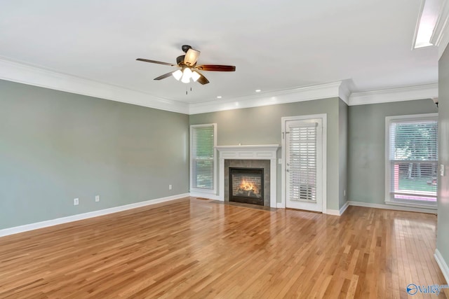 133 Raccoon Trce, Huntsville, AL 35806 - unfurnished living room featuring ceiling fan, light wood finished floors, a tile fireplace, and crown molding