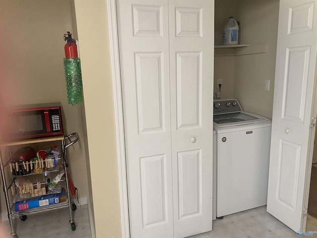 clothes washing area featuring washer / dryer