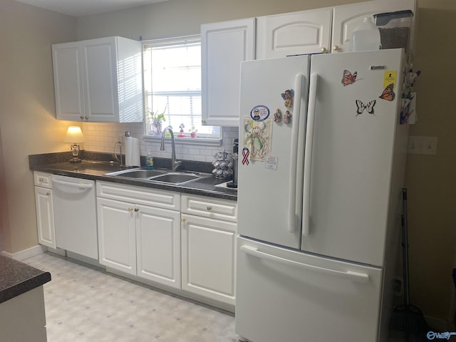 kitchen featuring sink, backsplash, white cabinets, and white appliances